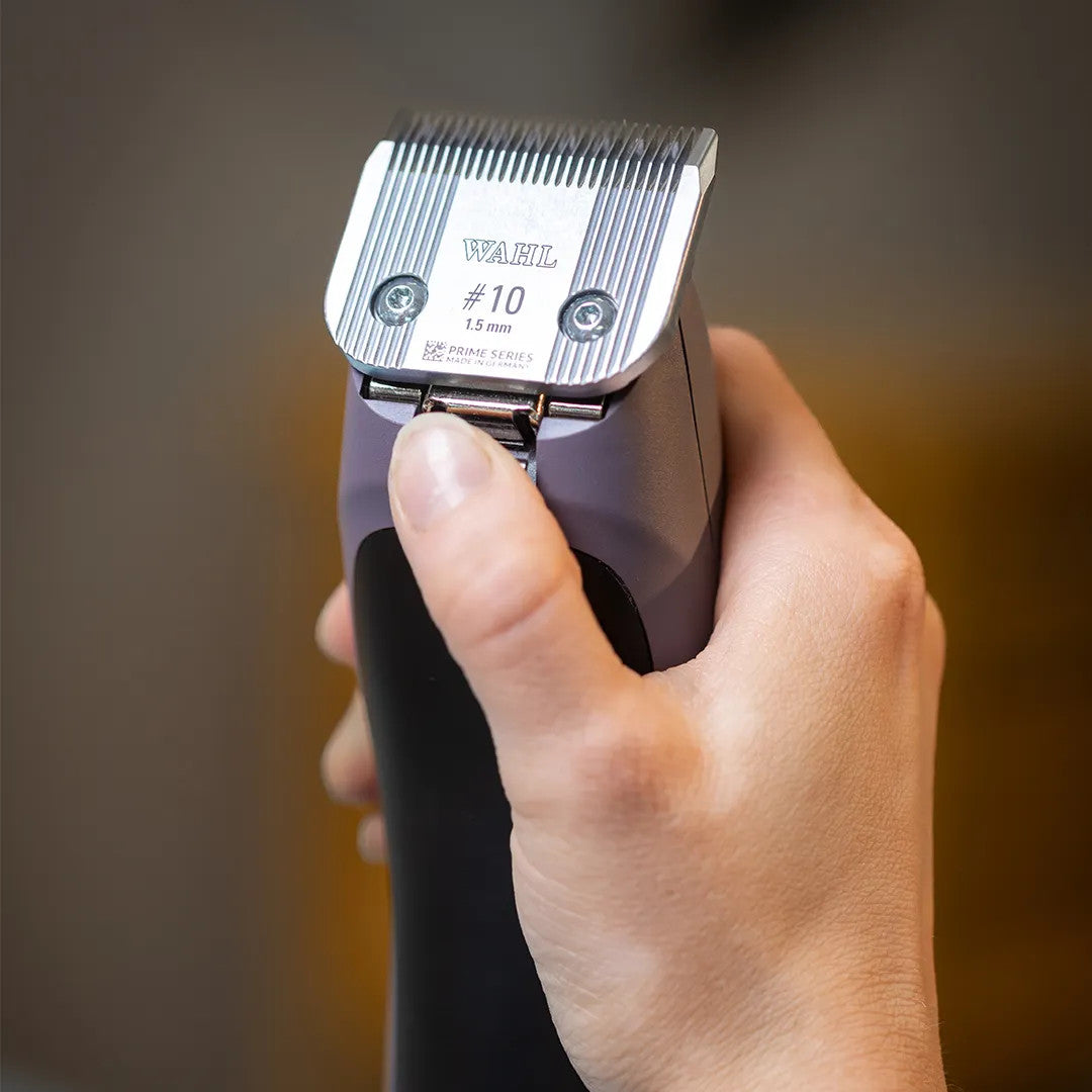 Close-up of a hand holding the Wahl KM Supera, highlighting its included #10 Prime Series Blade