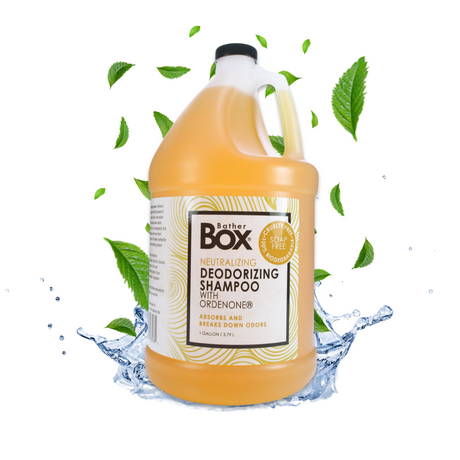 Gallon jug of BatherBox® Deodorizing Shampoo displayed alongside fresh leaves and glistening water droplets