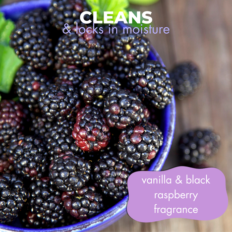 Close-up of freshly picked black raspberries in a bowl accompanied by the text: 'cleans and locks in moisture, vanilla & black raspberry fragrance'