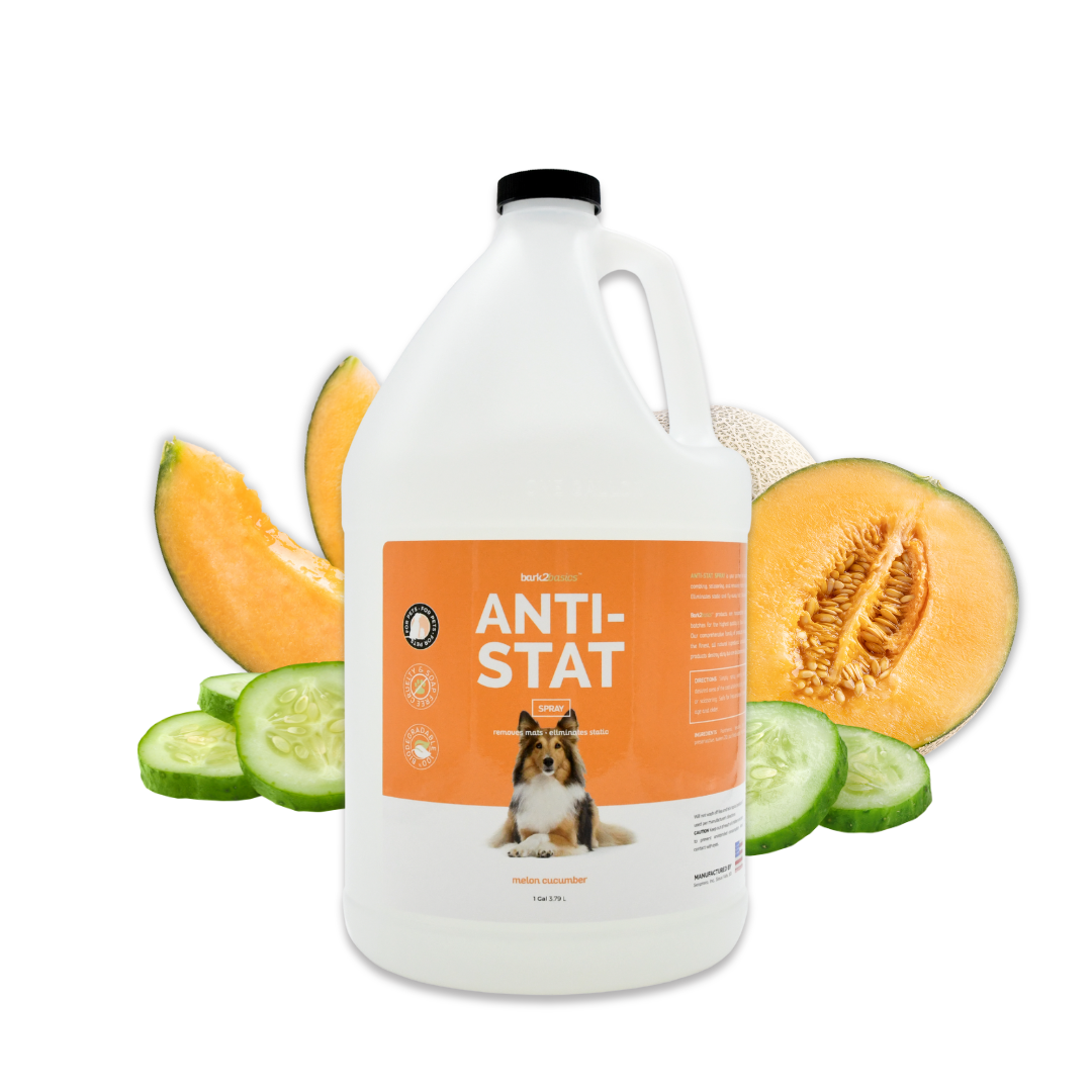 Gallon jug of Bark2Basics Anti-Stat Spray surrounded by cucumber rounds and fresh cantaloupe