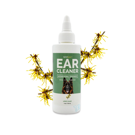 4 oz bottle of Bark2Basics Dog Ear Cleaner surrounded by witch hazel twigs