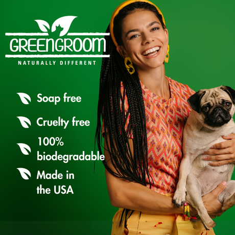 Smiling woman holding a pug with Green Groom branding and key product benefits: soap free, cruelty free, 100% biodegradable and made in the USA