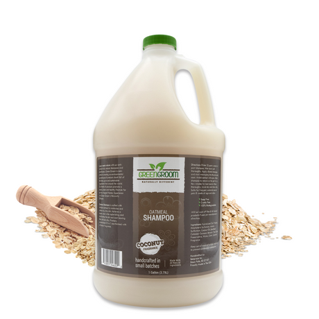 Gallon jug of Green Groom Oatmeal Shampoo displayed with rolled oats cascading from a wooden scoop
