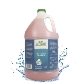 Gallon jug of Green Groom Odor Eliminator Shampoo emerging from a splash of clear water