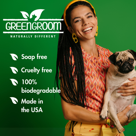 Smiling woman holding a pug with Green Groom branding and key product benefits: soap free, cruelty free, 100% biodegradable and made in the USA