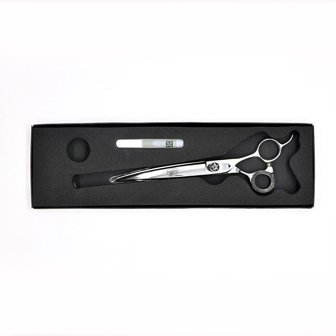 Monk Black 7.5" Curved Shear in a protective black foam-lined case with gel finger ring and shear oil