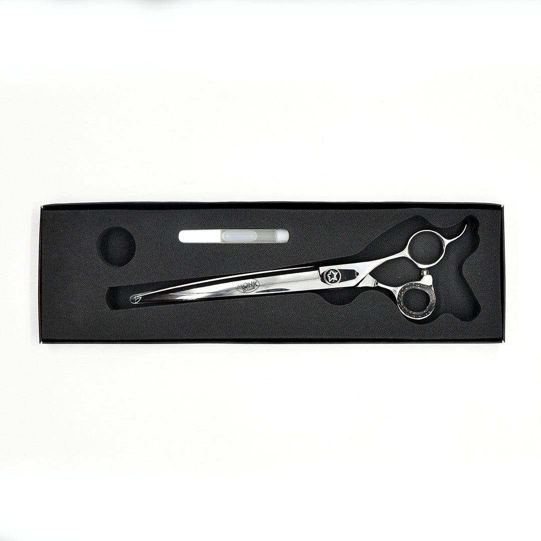 Monk Black 8.5" Curved Shear in a protective black foam-lined case with gel finger ring and shear oil
