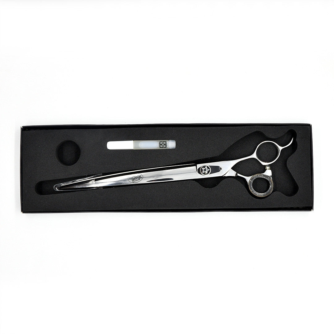 Monk Black 9.5" Curved Shear in a protective black foam-lined case with gel finger ring and shear oil