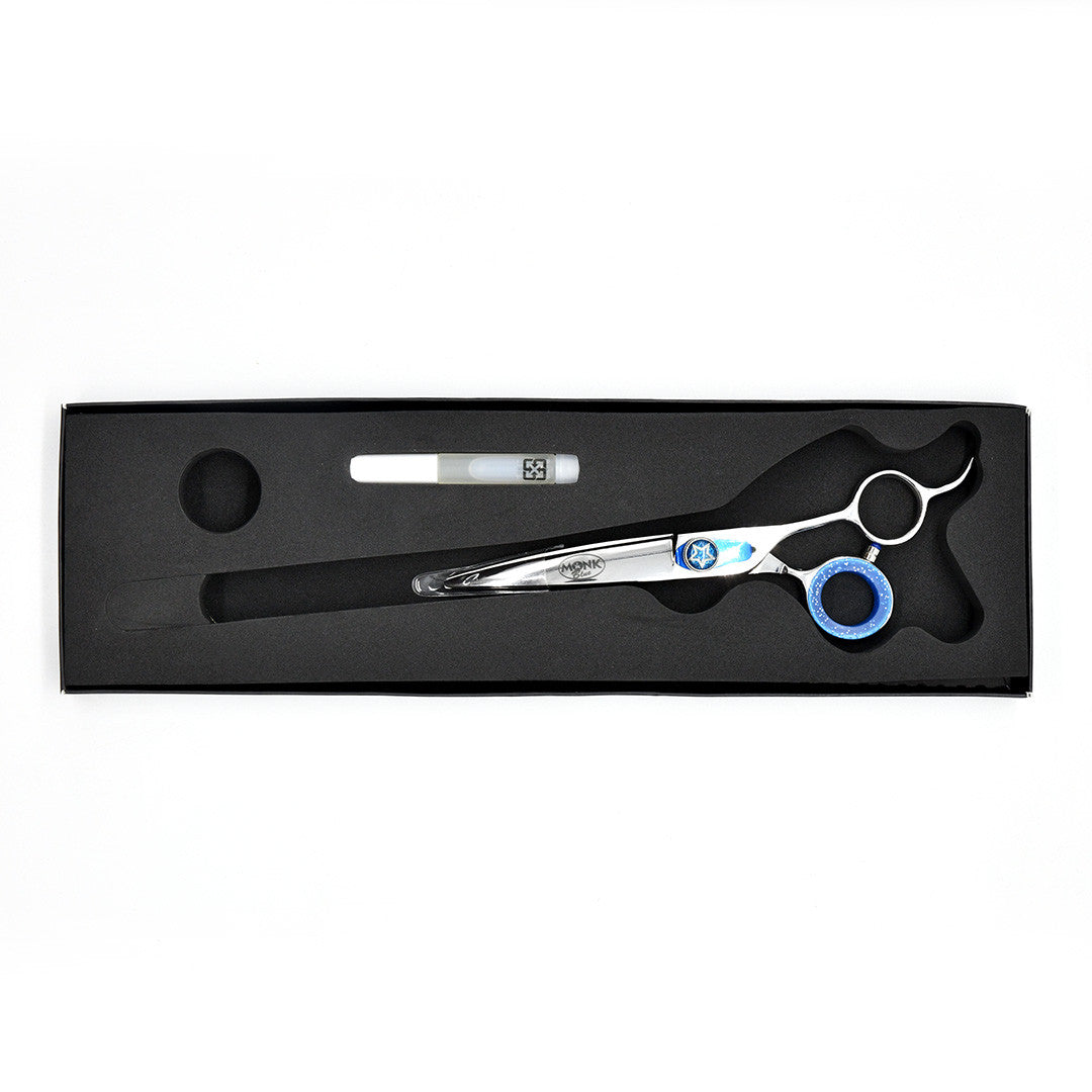 Monk Blue 6.5" Curved Shear in a protective black foam-lined case with gel finger ring and shear oil