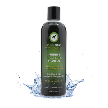 16 oz bottle of Petology Sensitive Therapeutic Shampoo, emerging from a splash of clear water