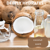 A freshly halved coconut next to a canister of coconut oil on a wooden surface, accompanied by the text: 'deeply hydrates and relieves irritation, coconut scent'