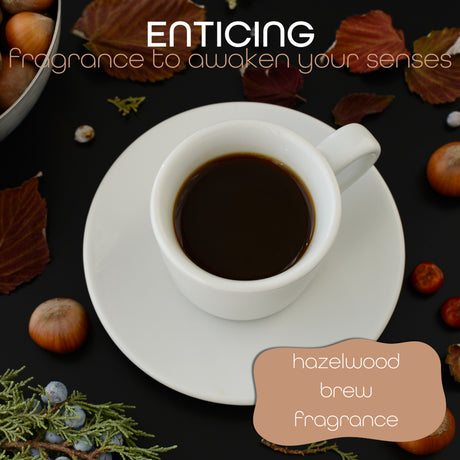 Cup of dark coffee on a saucer surrounded by autumn leaves, hazelnuts and greenery with text overlay reading 'enticing fragrance to awaken your senses, Hazelwood Brew fragrance'