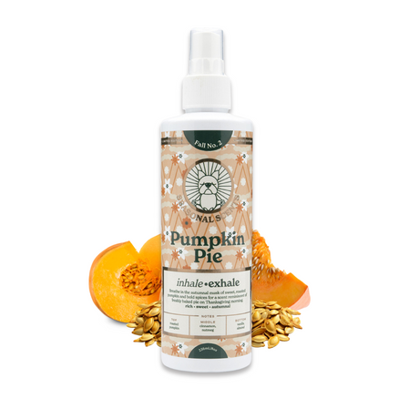 8 oz bottle of Seasonal Scents Pumpkin Pie Cologne, displayed with pieces of pumpkin and pumpkin seeds