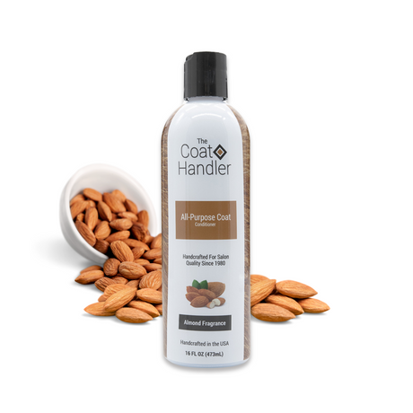 16 oz bottle of The Coat Handler All-Purpose Coat Conditioner displayed with whole almonds spilling from a white bowl