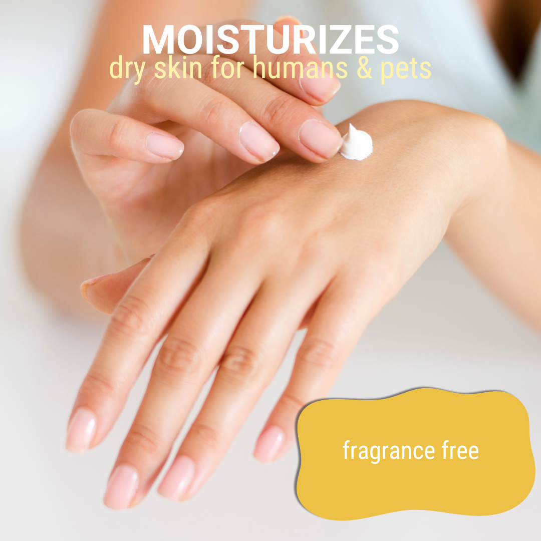 Close-up of moisturizing cream being applied to hands accompanied by the text: 'moisturizes dry skin for humans and pets, fragrance free'