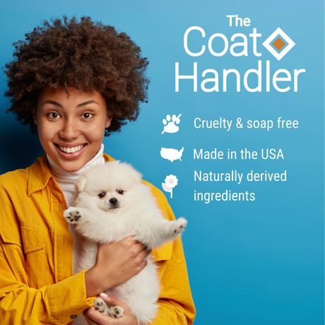 Smiling woman holding a Pomeranian with The Coat Handler branding and key product benefits: cruelty and soap free, naturally derived ingredients and made in the USA