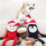 Three ZippyPaws Holiday Crinkle Dog Toys - Santa Claus, Moose and Penguin on a couch with a smiling Shiba Inu sitting behind them