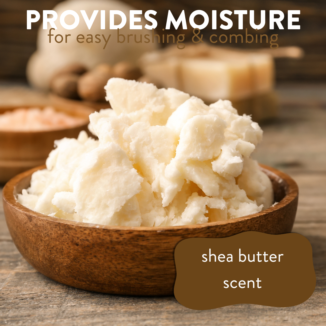 Creamy shea butter in a wooden bowl on a table, accompanied by the text: 'provides moisture for easy brushing and combing, shea butter scent'